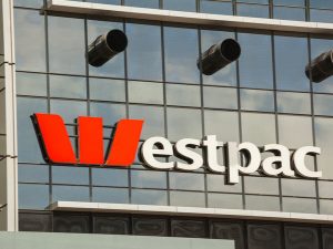 Westpac Group signage on a mirror glass building