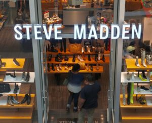 Steve Madden sign and shoppers at retail store